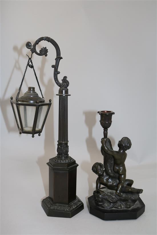 A bronze candlestick & a miniature lantern